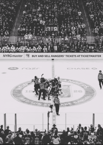 Players clash at center ice after Rangers score, sparking mayhem